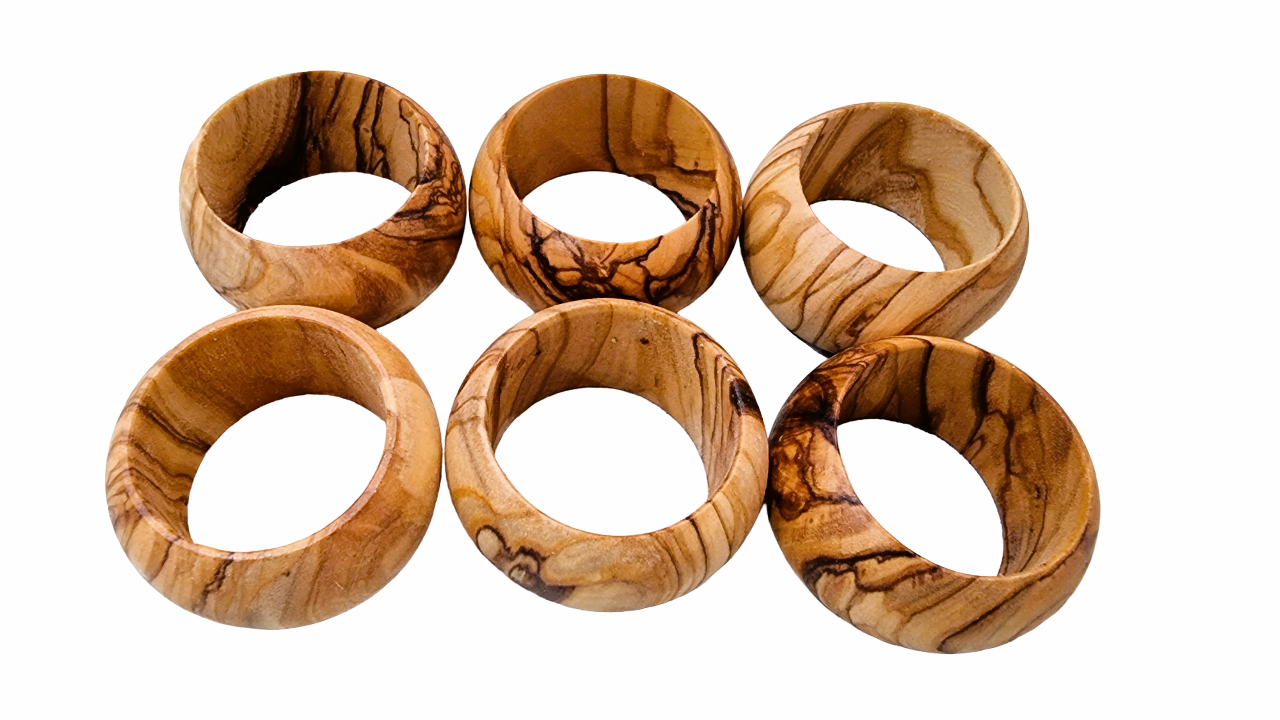 Six Olive Wood Napkin Rings On Display.