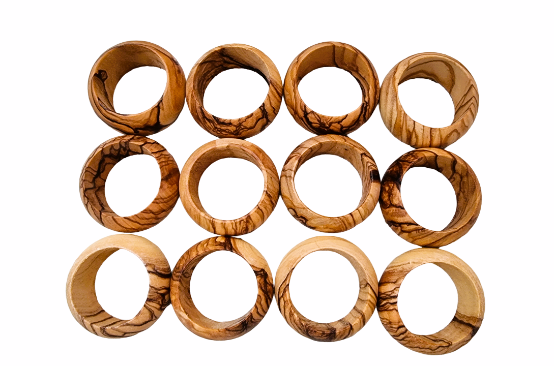 Twelve Olive Wood Napkin Rings Closely Together. 