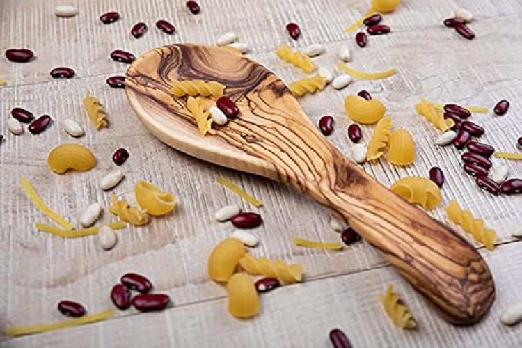 A Olive Wood Spoon Rest Displayed With Beans And Pasta Shapes.